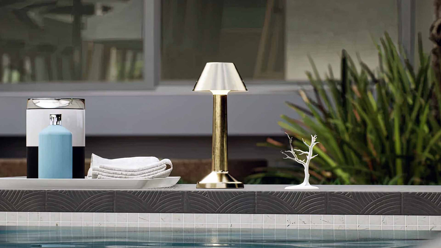Bella | Cordless Table Lamp | Iron, Acrylic | Gold color of product | Light off | Mid-range distance to lamp | Near outdoor pool | Noon