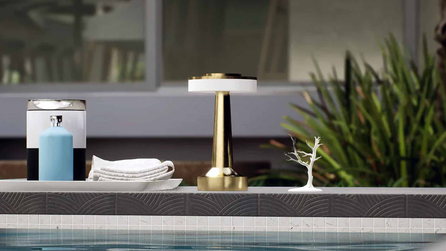 Halo Slim | Cordless Table Lamp | Iron, Acrylic | Gold color of product | Light off | Mid-range distance to lamp | Near outdoor pool | Noon