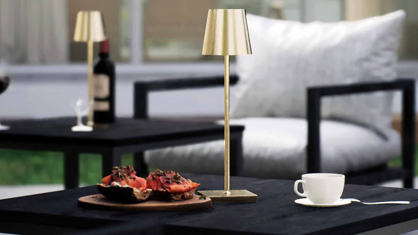Olivia | Cordless Table Lamp | Aluminum | Gold color of product | Light off | Mid-range distance to lamp | At backyard patio | Noon