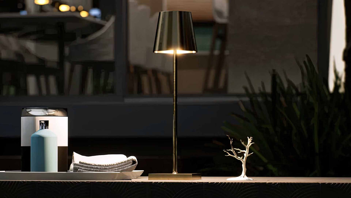 Olivia | Cordless Table Lamp | Aluminum | Gold color of product | Warm light on | Mid-range distance to lamp | Near outdoor pool | Evening