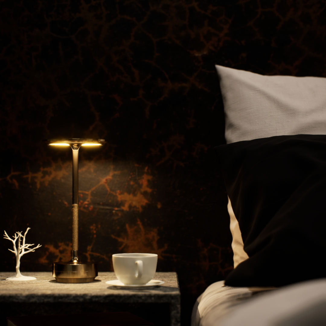 Amberly | Cordless Table Lamp | Aluminum | Gold color of product | Warm light on | Mid-range distance to lamp | At bedside table | Modern interior | Evening | scene 1