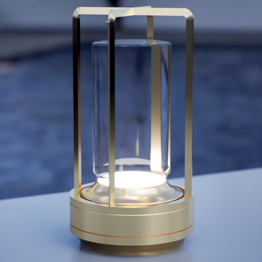 Amberly companion | Cordless Table Lamp | Aluminum | Gold color of product | White light on | Close-up distance to lamp | Near outdoor pool | Evening | Scene 4