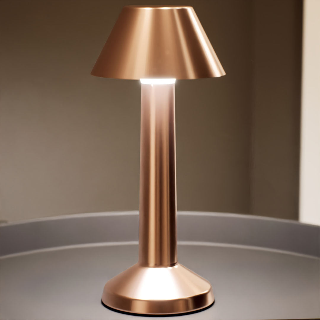 Bella | Cordless Table Lamp | Iron, Acrylic | Bronze color of product | Warm light on | Mid-range distance to lamp | At coffee table | Modern interior | Evening | Scene 4