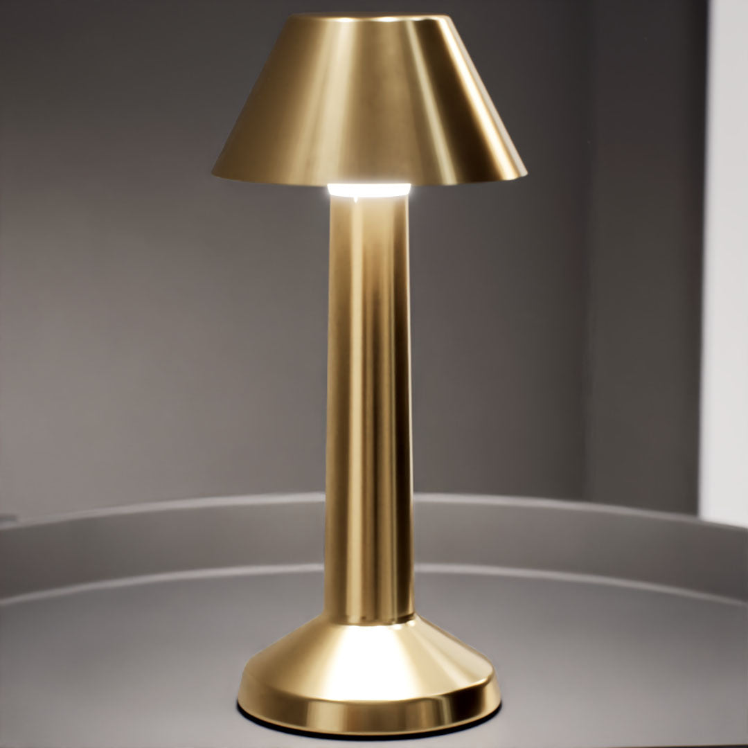 Bella | Cordless Table Lamp | Iron, Acrylic | Gold color of product | Warm light on | Mid-range distance to lamp | At coffee table | Modern interior | Evening | Scene 4