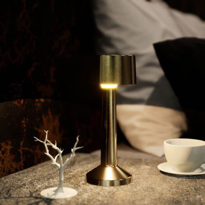 Copri | Cordless Table Lamp | Iron, Acrylic | Gold color of product | Warm light on | Close-up distance to lamp | At bedside table | Modern interior | Evening