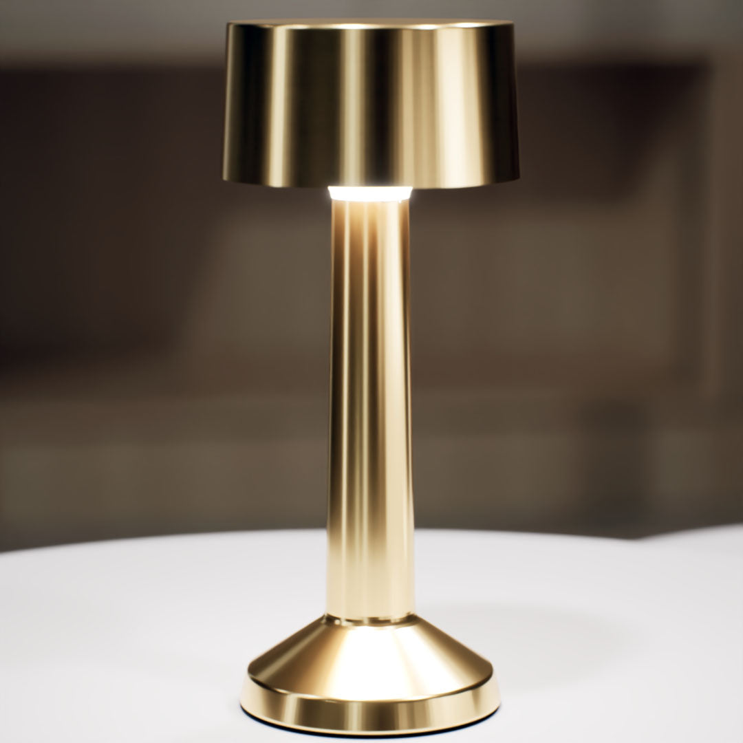 Copri | Cordless Table Lamp | Iron, Acrylic | Gold color of product | White light on | Close-up distance to lamp | At coffee table | Modern interior | Evening | Scene 4