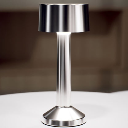 Copri | Cordless Table Lamp | Iron, Acrylic | Silver color of product | White light on | Close-up distance to lamp | At coffee table | Modern interior | Evening | Scene 4