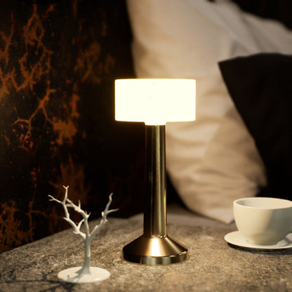 Halo | Cordless Table Lamp | Iron, Acrylic | Gold color of product | Warm light on | Close-up distance to lamp | At bedside table | Modern interior | Evening