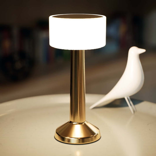 Halo | Cordless Table Lamp | Iron, Acrylic | Gold color of product | Warm light on | Close-up distance to lamp | At coffee table | Modern interior | Evening | Scene 3