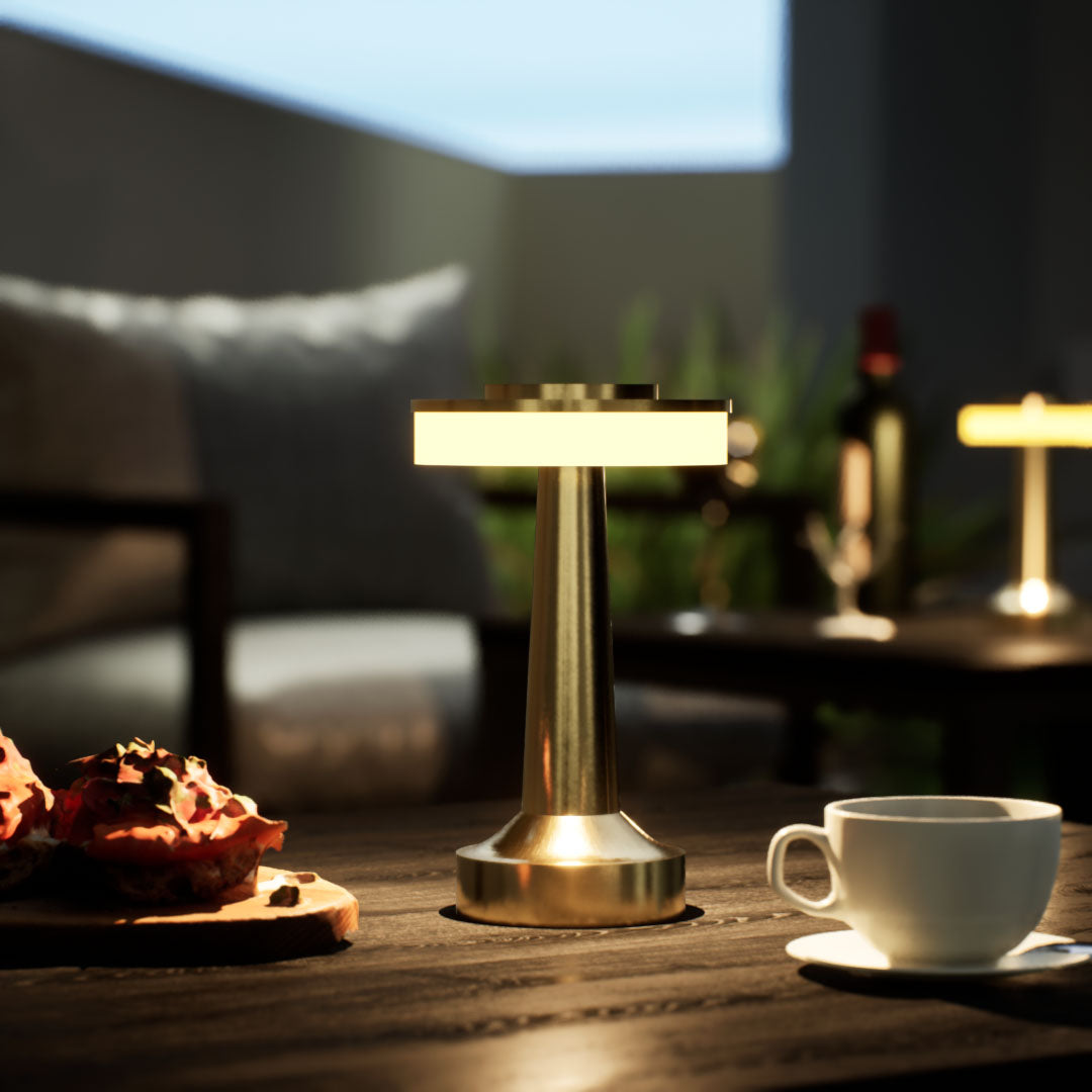 Halo Slim | Cordless Table Lamp | Iron, Acrylic | Gold color of product | Warm light on | Close-up distance to lamp | At backyard patio | Evening  | Scene 1