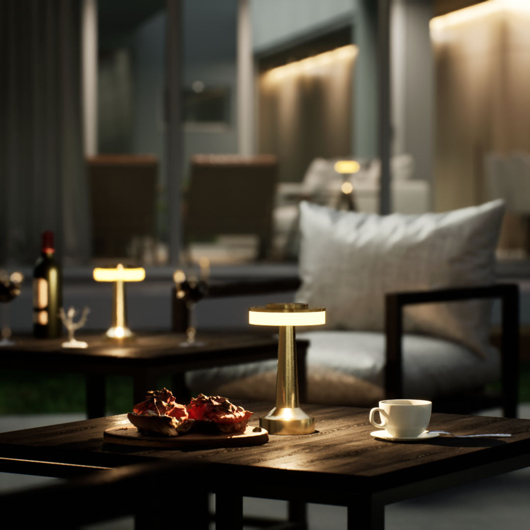 Halo Slim | Cordless Table Lamp | Iron, Acrylic | Gold color of product | Warm light on | Mid-range distance to lamp | At backyard patio | Evening