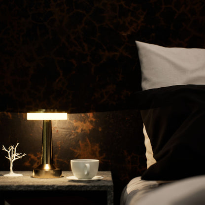 Halo Slim | Cordless Table Lamp | Iron, Acrylic | Gold color of product | Warm light on | Mid-range distance to lamp | At bedside table | Modern interior | Evening