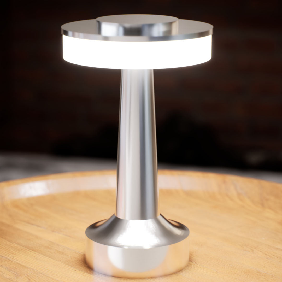 Halo Slim | Cordless Table Lamp | Iron, Acrylic | Silver color of product | White light on | Close-up distance to lamp | At coffee table | Modern interior | Evening | Scene 4