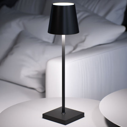 Olivia | Cordless Table Lamp | Aluminum | Black color of product | White light on | Close-up distance to lamp | At coffee table | Modern interior | Evening | Scene 4