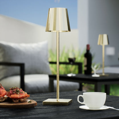 Olivia | Cordless Table Lamp | Aluminum | Gold color of product | Light off | Close-up distance to lamp | At backyard patio | Noon