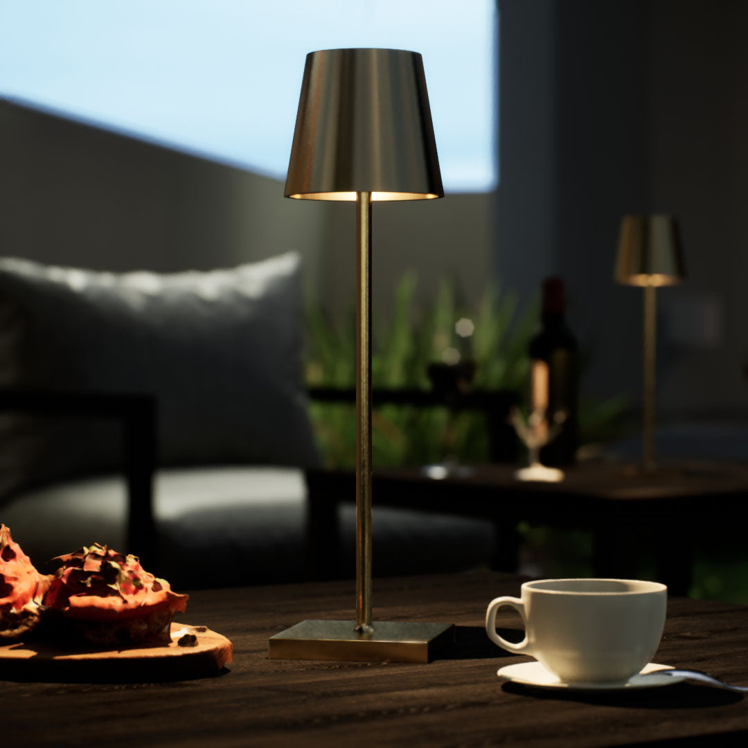 Olivia | Cordless Table Lamp | Aluminum | Gold color of product | Warm light on | Close-up distance to lamp | At backyard patio | Evening