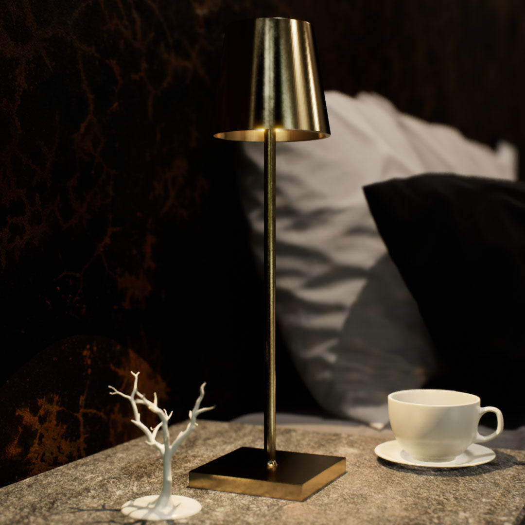 Olivia | Cordless Table Lamp | Aluminum | Gold color of product | Warm light on | Close-up distance to lamp | At bedside table | Modern interior | Evening