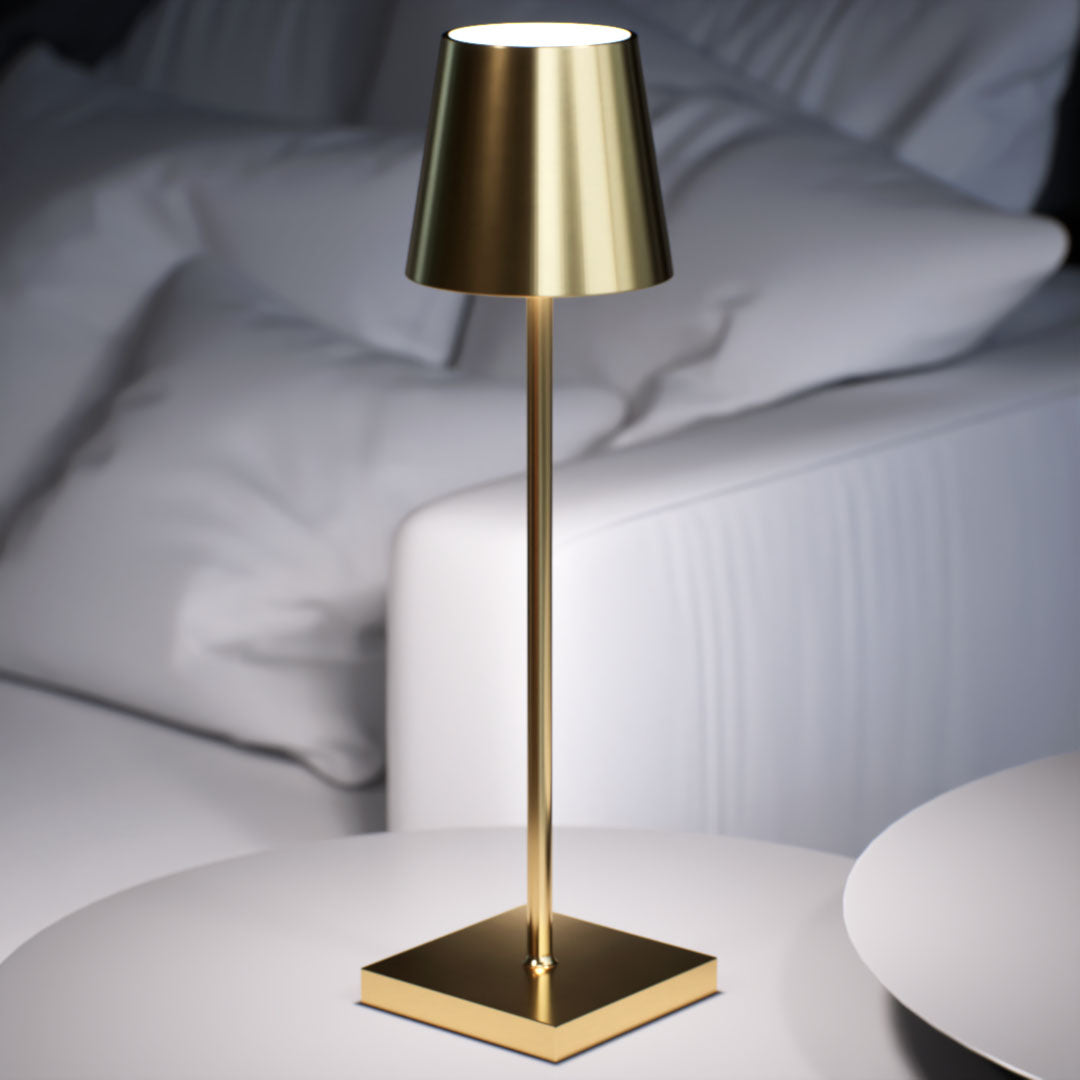 Olivia | Cordless Table Lamp | Aluminum | Gold color of product | White light on | Close-up distance to lamp | At coffee table | Modern interior | Evening | Scene 4