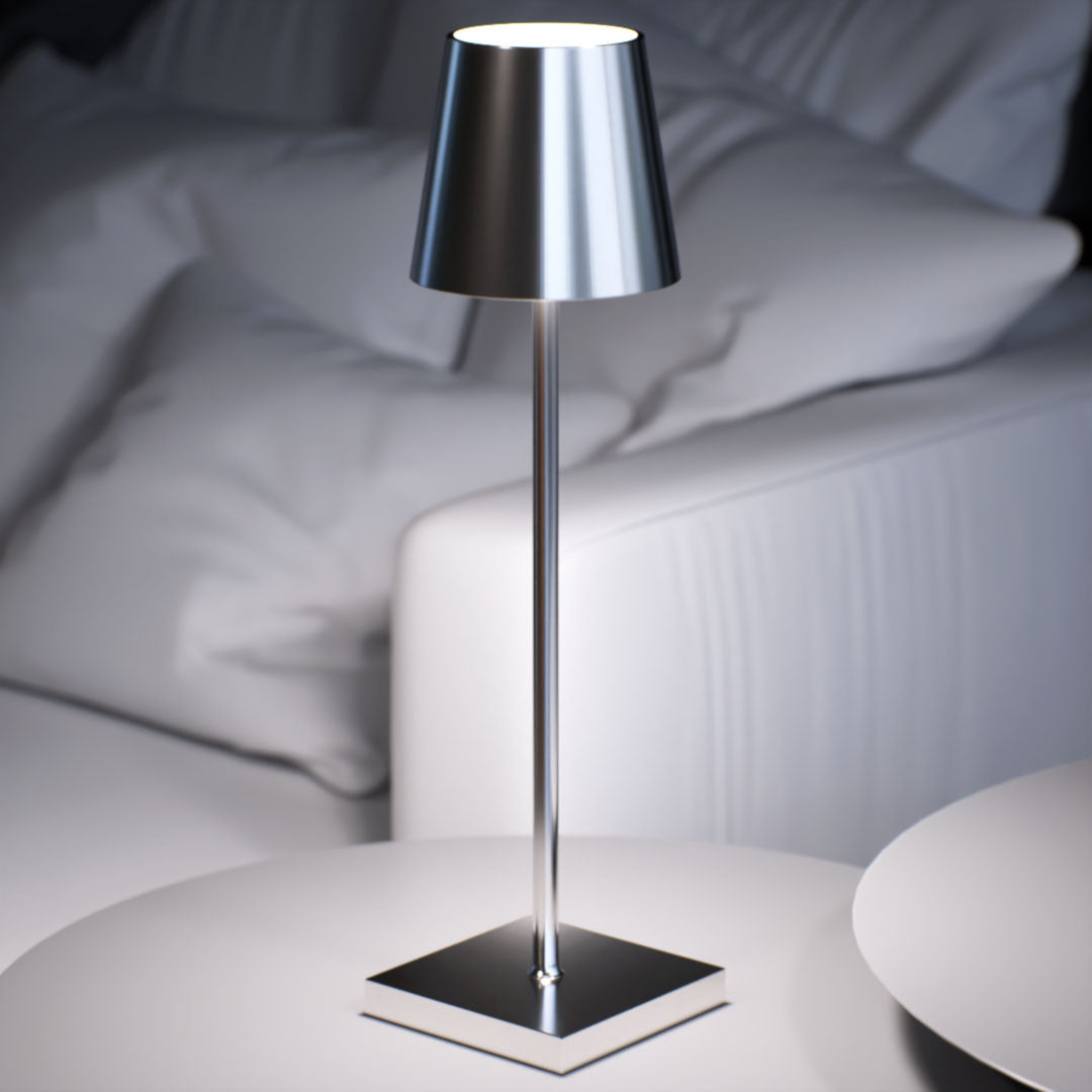 Olivia | Cordless Table Lamp | Aluminum | Silver color of product | White light on | Close-up distance to lamp | At coffee table | Modern interior | Evening | Scene 4